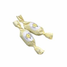 two lollipops wrapped in yellow and white checkered paper