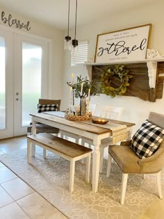 a dining room table with two chairs and a bench