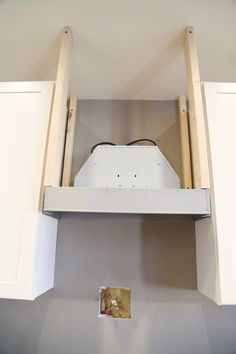 an overhead view of a kitchen with white cupboards and shelves above the countertop