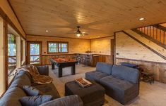 a living room filled with furniture and a pool table