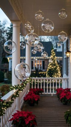 christmas decorations on the front porch of a house with lights and poinsettias