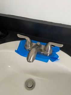 a close up of a bathroom sink with blue tissue