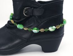 Lovely oval shaped lampwork glass beads and round glass beads are featured in this green boot chain. Gold plated beads in two different styles highlight the green beads. This boot jewelry features a gold-plated lobster claw clasp. If you are looking for a very unique gift under 30 dollars for her this boot bracelet will make a perfect birthday gift, anniversary gift, or any occasion gift. This boot jewelry is only available as a single bracelet that will be custom sized just for you. To choose your perfect size measure your boot and add 1/4 to a 1/2 inch depending on how you want them to fit. A two-inch-long extender chain will be included with the boot anklets.  You will receive that exact item pictured. It was handmade by me in my smoke free studio from high quality materials to ensure i Elegant Green Anklet For Gifts, Elegant Green Anklets For Gift, Boot Accessories Jewelry, Western Boot Jewelry, Boot Jewelry Bling, Boots Bracelets, Boot Jewelry Custom, Shoe Bracelet, Horsehair Jewelry