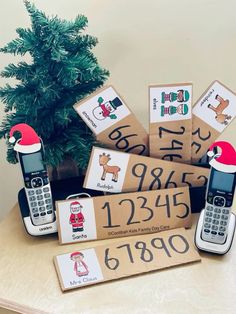 a group of cell phones sitting on top of a table next to a christmas tree