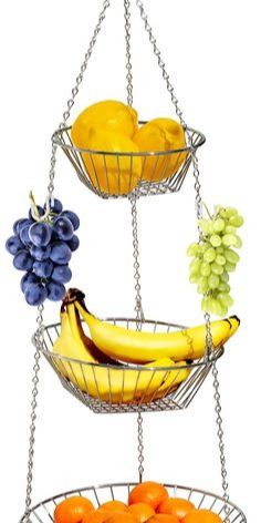 three tiered metal fruit basket with grapes, oranges and bananas hanging from chains