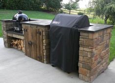 an outdoor bbq grill made out of wood with a cover on it's side