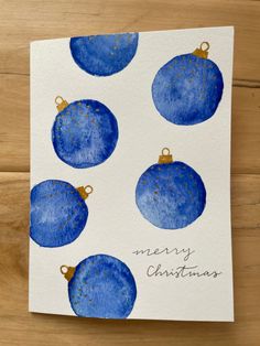 a card with blue christmas ornaments on it