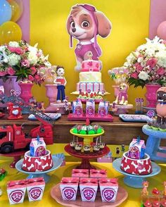 a table topped with lots of cakes and cupcakes