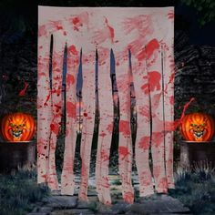 an image of halloween decorations with blood on the wall and pumpkins in the background