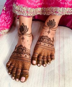 two feet with henna tattoos on them