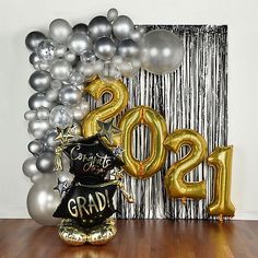 balloons and streamers in front of a backdrop with the number twenty one hundred two