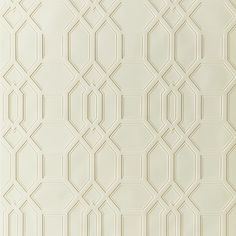 a white wall with an intricate pattern on it