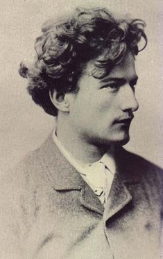 an old photo of a man with curly hair