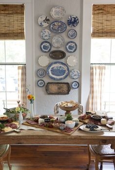 a dining room table with plates on the wall