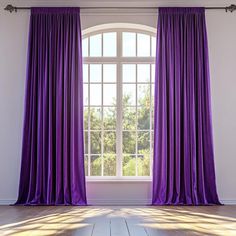 an open window with purple curtains in front of it