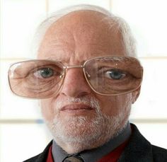 an old man with glasses and a tie is looking at the camera while wearing a suit