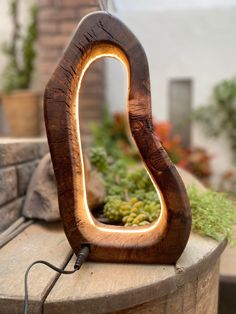 a wooden light that is on top of a table