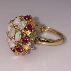 Absolutely Stunning! Vintage Estate Statement Ring. Solid 14k Yellow Gold (Partially Legible Stamp). Features Oval Opal And Round Cut Ruby Gemstones. The Opals And Rubies Are Set In An Intricately Detailed Leaf Design. With The Included Sizing Bar, The Ring Size Is Approximately 6 1/4 (6.25). You Can Remove The Sizing Bar If Needed. Substantial, Bold Design. A Piece Of Art, An Amazing Gift. I Don’t Need To Sell. Price Is Firm Please, No Trades. Opal Is The Birthstone For Those Born In October. T Fine Jewelry Opal Ring With Multi-stone For Anniversary, 14k Gold Multi-stone Round Jewelry, Formal 14k Gold Opal Ring, White Cluster Ring Stamped 14k, Elegant Multi-stone Opal Ring For Collectors, Exquisite Multi-stone Opal Ring For Formal Occasions, 14k Gold Red Multi-stone Cluster Ring, Collectible Ruby Ring In Fine Jewelry Style, White Round Ruby Ring In Fine Jewelry Style