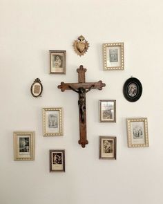 a cross is surrounded by many framed photos