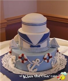 a blue and white cake with an anchor on top