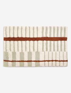 a white rug with brown stripes on it