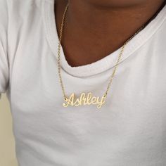 Dress your little ones with our original nameplate! Customize this necklace with a name or a meaningful word. Crafted from 18K gold and silver plating, this piece is durable and made to last. Details: Personalize With: Names, Numbers, or Words. Pendant Size varies by name (3.5cm-5cm) Matching Link Chain Closure: Lobster Clasp Trendy Gold Name Necklace For Personalized Gift, Gold Plated Hallmarked Name Necklace, Trendy Gold Metal Name Necklace, Customized Gold-plated Elegant Name Necklace, Customized Gold Metal Name Necklace, Name Necklace Silver, Jewelry Gift Guide, Dainty Initial Necklace, Photo Necklace