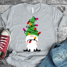 a t - shirt with an image of a gnome wearing a christmas tree on it