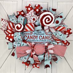 a wreath with candy canes hanging on the front door