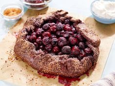 a chocolate cake with cranberries and powdered sugar