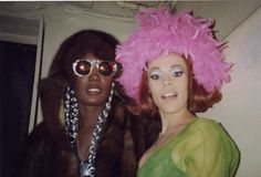 two women wearing pink wigs and sunglasses