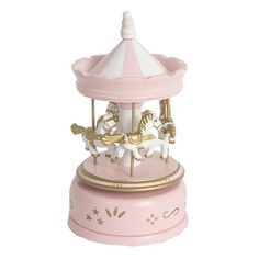 a pink carousel with white and gold horses