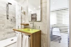 a bathroom with a sink, mirror and towel rack