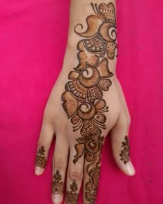 the hand is decorated with henna designs