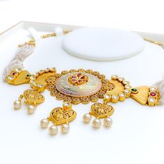 This 22k gold necklace set, weighing 62.1 grams, showcases an imperial and classy floral design with an antique finish, adorned with Kundan and pearl accents. The necklace measures 17 inches in length with a 1.25-inch drop and includes 0.8-inch adjustable links, secured with a hook lock. The set includes matching earrings, each 1.6 inches in length with a screw back post. Ideal for those who appreciate luxurious and timeless jewelry, this set combines the regal elegance of antique gold with the traditional beauty of Kundan and pearls, making it a standout piece perfect for enhancing your personal style. PRODUCT DETAILS Gold Purity(karat): 22k Item Weight(grams): 62.1 Item Finish: Antique Finish Stone: Kundan + Pearl Set Length: 17" Drop Length: 1.25" Adjustable Links: 0.8" Links Lock Style Traditional 22k Gold Pearl Necklace For Festive Occasions, Traditional 22k Yellow Gold Pearl Necklace, Festive 22k Gold Pearl Necklace With Tilla Details, 22k Gold Pearl Necklace For Diwali, Ornate 22k Yellow Gold Kundan Necklace, Festive 22k Gold Pearl Necklace With Intricate Design, Ornate Kundan Necklace In 22k Yellow Gold, Elegant 22k Gold Pearl Necklace With Meenakari, Gold Pearl Necklace With Intricate Design For Diwali