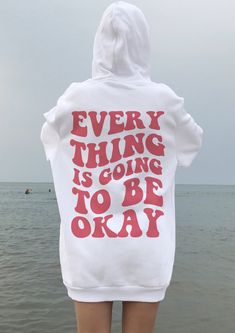 Everything Is Going To Be Okay Hoodie ,Saying Hoodie, Aesthetic Hoodie,Word' On Back Hoodie, Tumblr Hoodie, Positivity Hoodie ,Saying Hoodie A unisex heavy blend hooded sweatshirt is relaxation itself. The material is a thick blend of cotton and polyester. This makes for a plush, soft feel alongside warmth. It's also a great surface for printing. There are no side seams. A spacious kangaroo pocket hangs in front. The hood's drawstring is the same color as the base sweater.  .: 50% Cotton 50% Pol Vsco Hoodie, Hoodie Outfits, Positive Hoodie, Outfit Hoodie, Hoodie Aesthetic, Aesthetic Hoodie, Be Okay, Style Hoodie, Hoodie Outfit