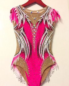 a woman's leotard with pink and white feathers