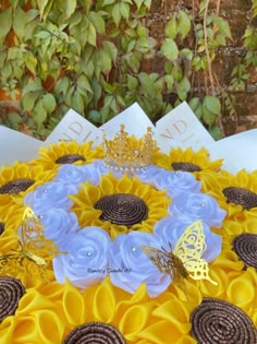 a sunflower centerpiece with blue and yellow flowers on it, surrounded by butterflies