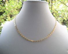 Early 70's gold plated choker - Coffee bean chain gold plated: length: see variations; made in W. Germany - Ring clasp  gold plated and rings: length - 1 cm/0.39in made in W. Germany - Length total:  40cm/ 15.7in      Total weight: 6 gr. Link: 0.4X0.3 cm/0.157X0.118in Mint vintage condition We highly recommend avoiding direct contact with water (like swimming or showering), perfumes,, and lotions. We also recommend that you take off your jewelry when you work out or go to the beach.  . Shop Poli Gold Link Choker For Gifts, Yellow Gold Chain Choker As Gift, Gold Chain Link Choker For Gift, Gold Link Chain Choker, Yellow Gold Choker With Gold Chain As Gift, Gold-plated Delicate Chain Choker, Adjustable Gold Oval Link Chain Necklace, Gold Metal Dainty Choker, Gold Plated Delicate Chain Choker