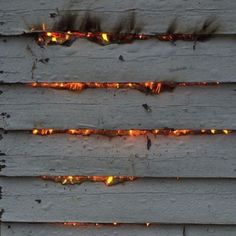 the fire is burning on the wooden siding