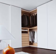 an open closet with clothes hanging in it