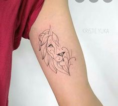 a woman's arm with a lion tattoo on the left side of her body