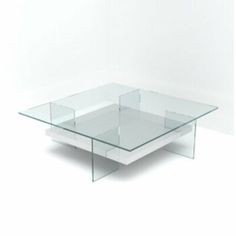 a glass coffee table sitting on top of a white floor