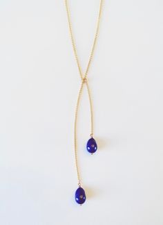 Two hand carved Lapis pearls complete this simple and elegant 18k lariat necklace. Simply tie around your neck.     23” long chain    Please allow 6-8 weeks for completion as each piece is made to order. Pearl Lariat, Jewelry Studio, Lariat Necklace, Long Chain, 8 Weeks, Hand Carved, Carving, Pendant Necklace, Chain