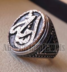 Customized Arabic calligraphy names ring personalized antique jewelry style sterling silver 925 and bronze all size TSB1002 خاتم اسم تفصيل This is made to order item please allow 2 - 3 weeks before shipping . Any name can be applied one or two parts . Please write the name/s in the order notes in Arabic or English . A sketch drawing ( see Pics ) will be sent to you after 2 - 5 days from order before we proceed to production . Ring face dimensions 21 mm X 16 mm Sterling silver 925 is used and bro Bronze Engraved Rings For Gift, Bronze Engraved Rings Ideal For Gifts, Engraved Bronze Rings Gift, Engraved Bronze Rings Ideal For Gifts, Antique Engraved Ring With Antique Finish As Gift, Antique Bronze Engraved Ring For Gift, Antique Engraved Ring As Gift With Antique Finish, Anniversary Engraved Bronze Ring, Silver Rings With Antique Finish As Gift