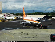 an orange and white airplane is on the runway