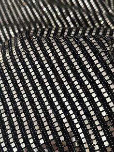 "Good quality and fast shipping." Angela K. Verified Kikitextiles Customer ✅ Bring on the shimmer with our very sparkly Metallic Flat Sequins on Black Glittery Knit. At full glimmer, this medium-weight sequined fabric is a 4 way stretch. Fully opaque, this fabric doesn't require a lining.This fabric is made up of a combination of materials including nylon spandex and sequins. The fabric has a shiny, reflective surface due to the presence of small mirror-like sequins that are attached to it. The Thread And Needle, Sequined Fabric, Metallic Flats, Small Mirror, Reflective Surfaces, Small Mirrors, Synthetic Materials, The Velvet, Silver Foil