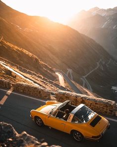 an orange sports car driving down the road