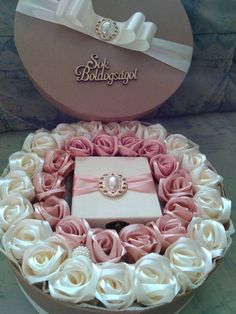 a pink and white box with roses in it