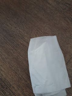 a piece of white paper sitting on top of a wooden table