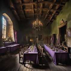 a dining room with purple tablecloths and chandelier